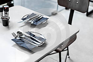 empty plate with knife spoon and fork on table