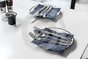 empty plate with knife spoon and fork on table