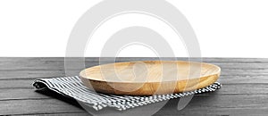 Empty plate and napkin on wooden table