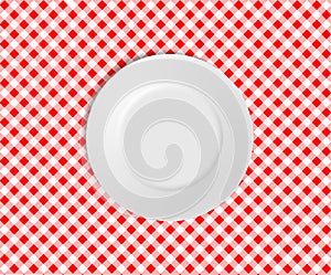 Empty plate on a red checked tablecloth photo