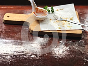 Empty plate of serving size, Bread pizza and ketchup on wooden tray.