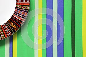 Empty plate on striped tablecloth