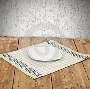 Empty plate on tablecloth