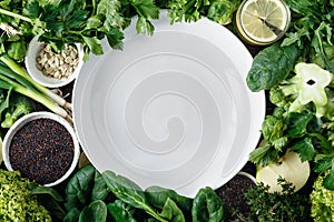 Empty plate vegetables fruit herbs superfood water top view Healthy food ingredients background