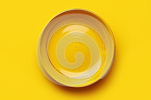 Empty plate on yellow background, intermittent fasting concept.