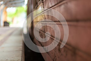 Empty platform of a railway station in Sri Lanka. Old rusty train cars. It looks like an abandoned place, but its not