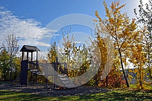 Empty playground at autumn, colorfuly leaves, sunny blue sky