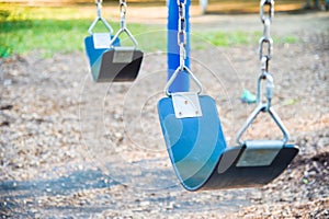 Empty playground blue swing set