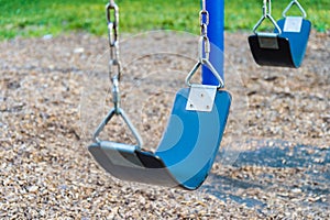 Empty playground blue swing set