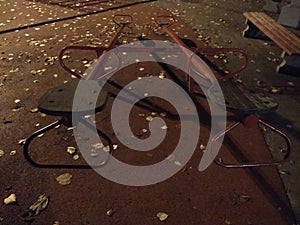 An empty playground with metal teeter at night and creepy atmosphere