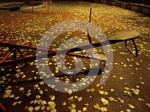 An empty playground with metal teeter at night and creepy atmosphere