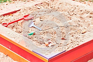 Empty playground sandbox with abandoned toys