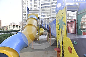 An empty playground under heavy rain, a downpour with a strong wind. big puddles, summer rainy day.