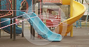 Empty playgrounds covered with a protective tape during quarantine of coronavirus, covid-19 virus.