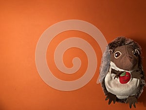 Empty postcard with mole figure, note paper on orange background