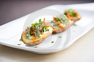 empty potato skins on a white plate with a parsley garnish