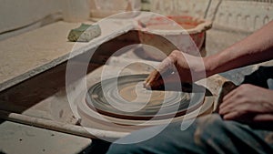 An empty pottery wheel, preparing surface for clay artworks. Professional potter makes masterclass using spinning work