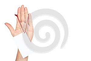 Empty price tag with red string in hand, isolated on white background. copy space template