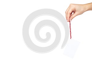 Empty price tag with red string in hand, isolated on white background. copy space template