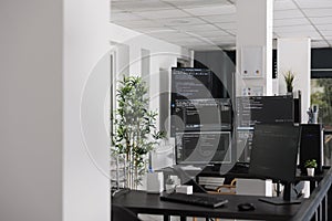Empty programming office with computer monitors on desk