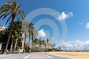 Empty promenade Passeig de la Ribera with the views of church Sant Bartomeu y Santa Tecla, Sitges, Catalonia, Spain