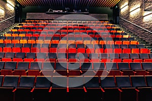 Empty public theatre or cinema auditorium hall with rows of seats or chairs
