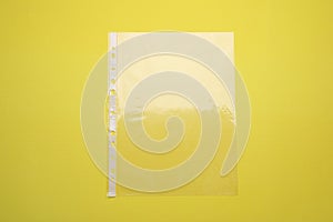 Empty punched pocket on yellow background, top view