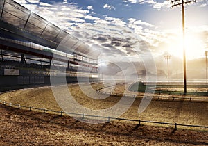 Empty race track near mountain with stadium lights