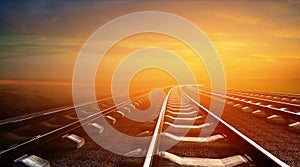 Empty railways on sunset sky background
