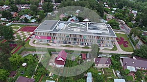 Empty rainbow beautiful new modern school in a small village. aerial wiev