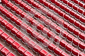 Empty ranges of red seats in a stadium