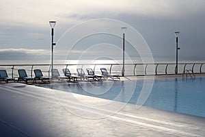 Empty Recreation area with pool and beach lounger near the sea. Evening nature calm landscape