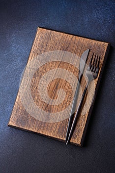 Empty rectangular wooden cutting board on dark concrete background