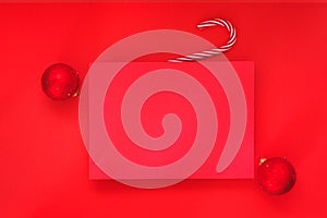 Empty red background and blank Christmas paper sheet with red baubles