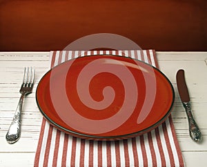 Empty red ceramic plate