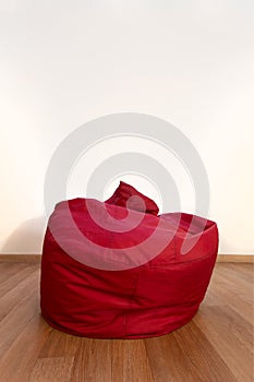 Empty red chair bag in living room with wooden floor