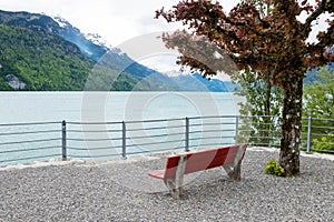 Empty red chair and landscape from Brienz town in Switzerland.