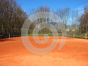 Empty Red Clay Tennis Court in Summer