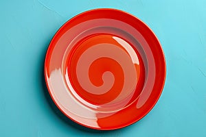 Empty red plate on blue background, intermittent fasting concept.