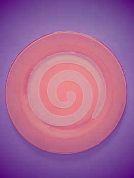 Empty red plate on purple