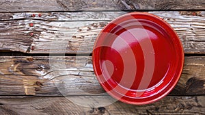 Empty red plate rests on rustic wooden tabletop, bathed in warm sunlight. Ai Generated