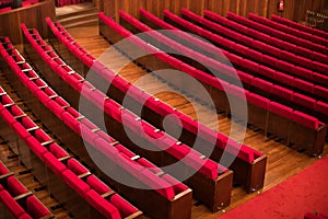 Empty red seats in a conference room