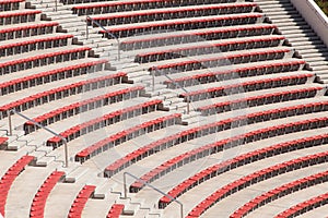 Empty red seats on football stadium or amphitheater