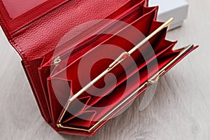 Empty red women wallet on gray background