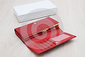 Empty red women wallet on gray background