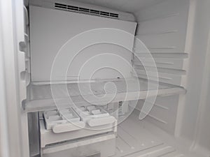 Empty refrigerator shelves closeup. Freezer chamber