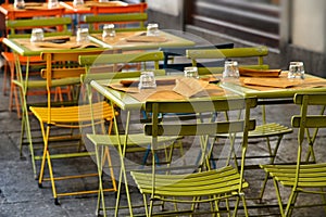 Empty restaurant tables set in the terrace waiting customers for dinner