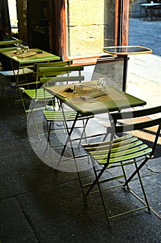 Empty restaurant tables set in the terrace waiting customers for dinner