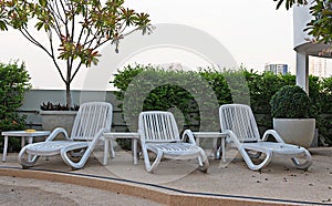 Empty resting chair near children swimming pool in hotel