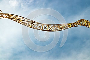 Empty ride roller coaster in amusement park on blue sky background